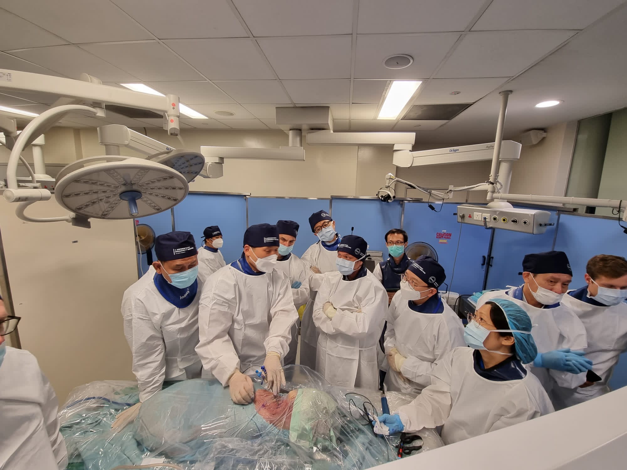 Many asian doctors in an operation room training endoscopic spine surgery